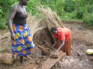 Akello and her mother laying bricks in Bar Opok village, Apac district 